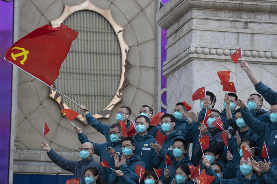 FILE - A farewell ceremony is held for the last group of medical workers who came from outside Wuhan to help the city during the coronavirus outbreak in Wuhan in central China's Hubei province on April 15, 2020. The hunt for COVID-19 origins has gone dark in China. An AP investigation drawing on thousands of pages of undisclosed emails and documents and dozens of interviews found feuding officials and fear of blame ended meaningful Chinese and international efforts to trace the virus almost as soon as they began, despite years of public statements to the contrary. (AP Photo/Ng Han Guan, File)