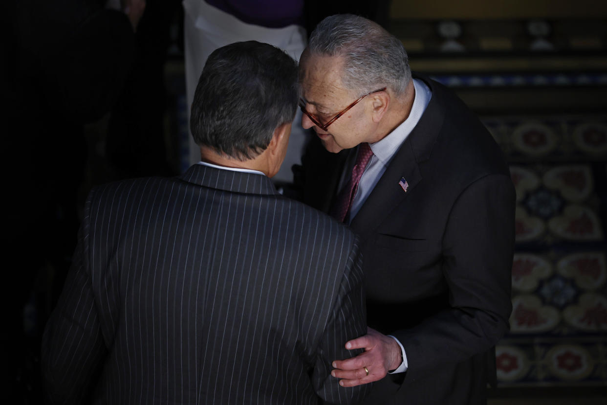 WASHINGTON, DC - MARCH 15: Sen. Joe Manchin (D-WV) (L) talks with Senate Majority Leader Charles Schumer (D-NY) before the ceremony where U.S. President Joe Biden signed the “Consolidated Appropriations Act