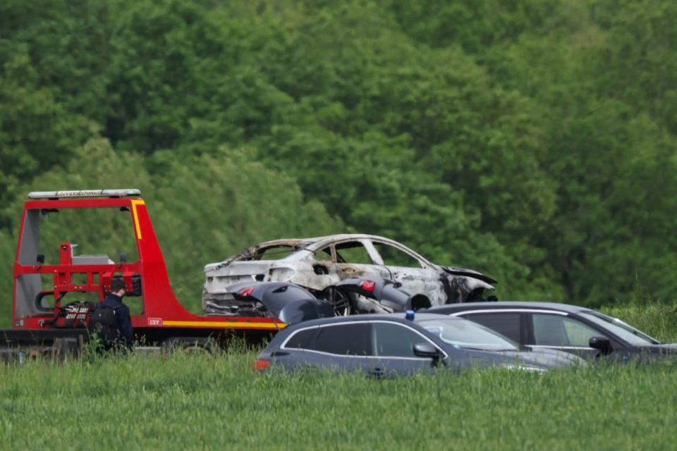 French authorities tow a burnt out vehicle used in the attack (AFP via Getty Images)