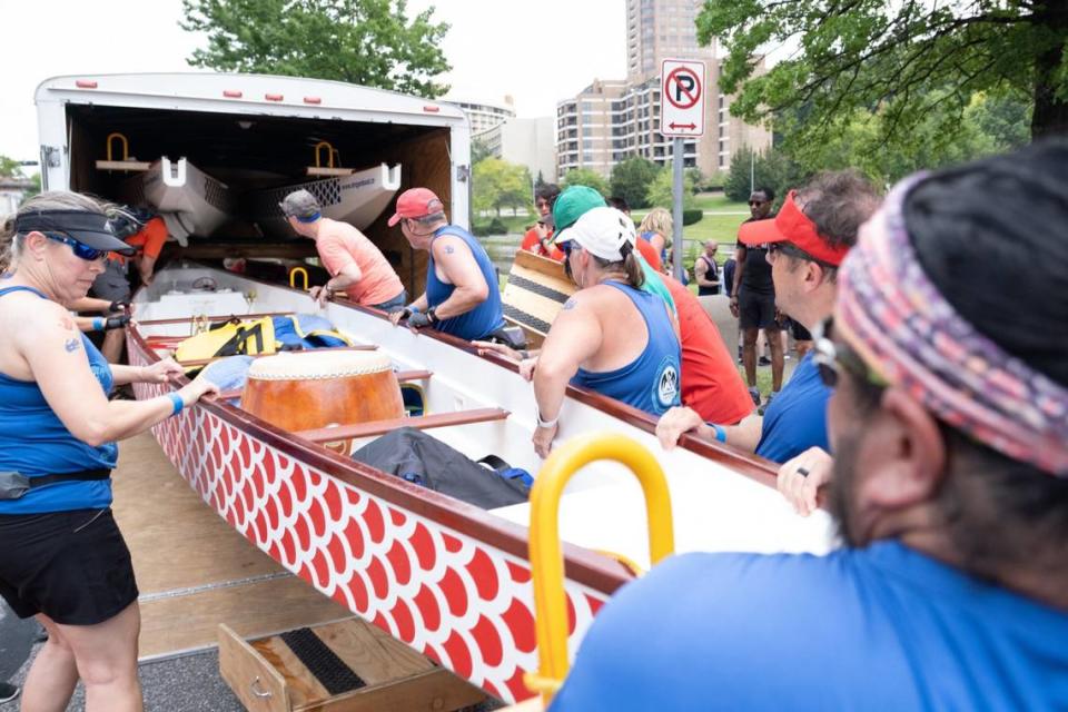 Dragon boat race team members help load the dragon boats into a trailer for storage after the 35th annual Kansas City Dragon Boat Festival on Saturday, June 15, 2024, along Bush Creek in Kansas City.