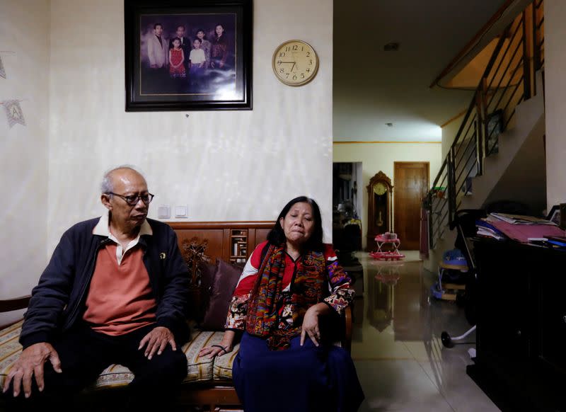 Bambang Purnomo Sidik, 72, and Nina Widyawati, 65, react as they talk about their daughter Ratih Purwarini, a doctor who passed away due to the coronavirus disease (COVID-19), at their house in Jakarta