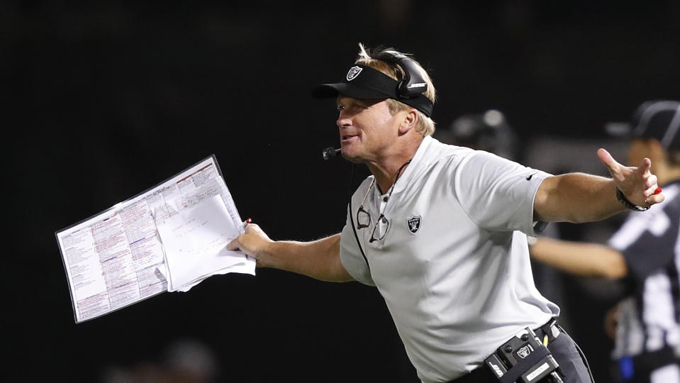 Jon Gruden was grabbed by Lee Smith during Sunday’s game. (AP Photo/John Hefti)