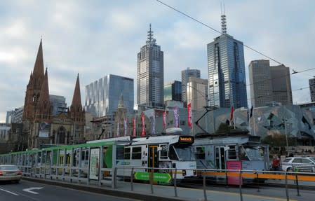 Trams pass by Melbourne's city skyline in Australia's second-largest city