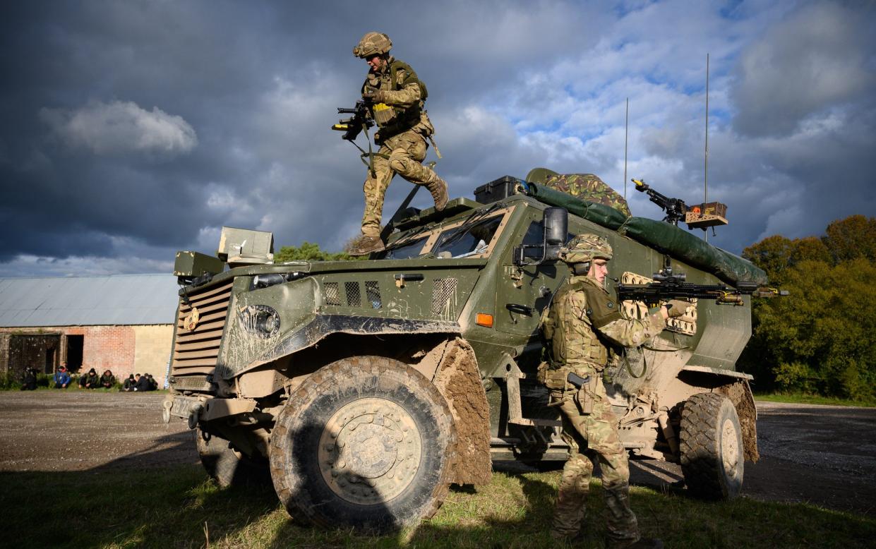 Soldiers from the Royal Anglian Regiment leap from their Foxhound protected patrol vehicle during a mission rehearsal exercise in Salisbury, Wiltshire - Leon Neal /Getty