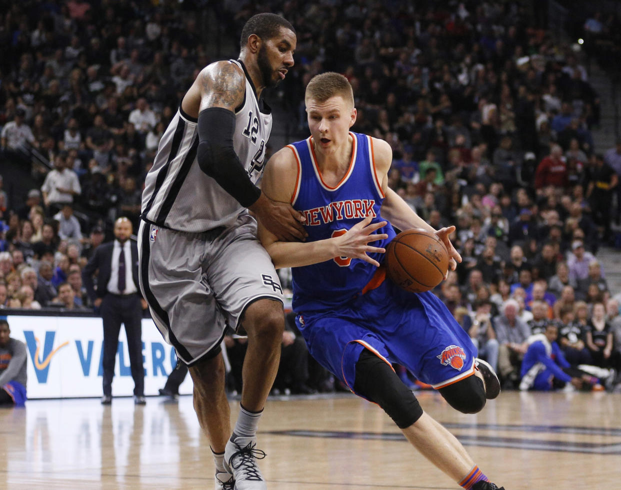 Jan 8, 2016; San Antonio, TX, USA; New York Knicks power forward Kristaps Porzingis (right) drives to the basket as San Antonio Spurs power forward LaMarcus Aldridge (12) defends during the second half at AT&T Center. Mandatory Credit: Soobum Im-USA TODAY Sports