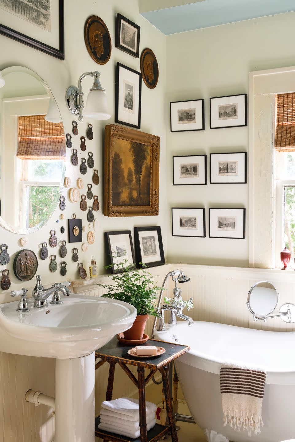 bathroom with collection of antique bottle openers and vintage tools hung on the wall