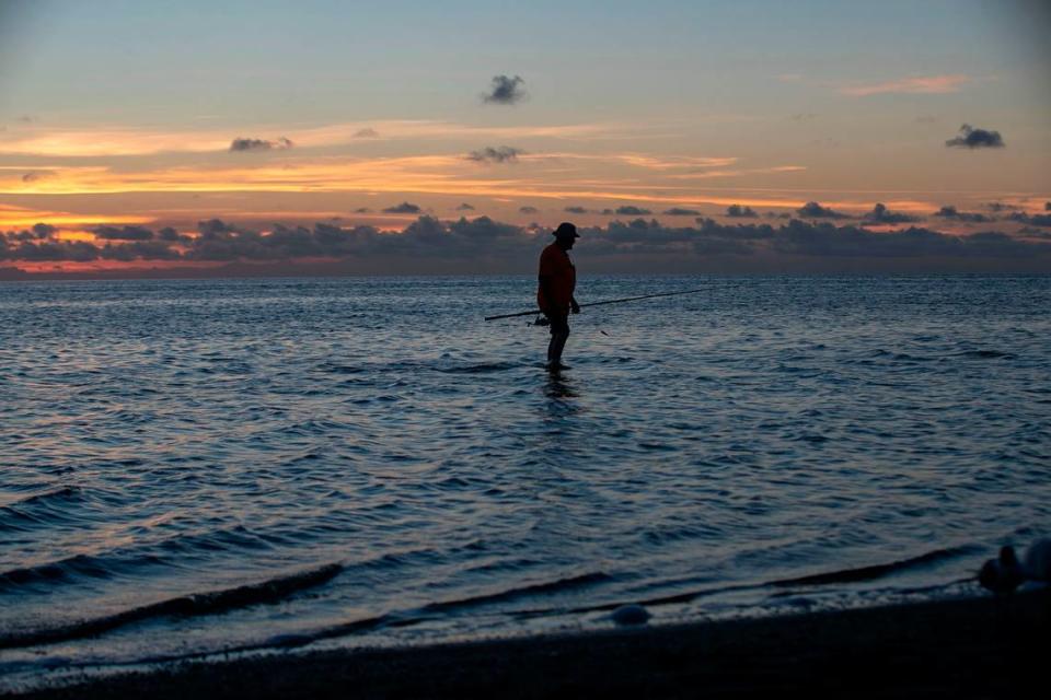 Del Purkey of Alexandria Va, walks to shore after fishing in the Pamlico Sound at Kite Point on Tuesday, June 29, 2021 near Buxton, N.C.