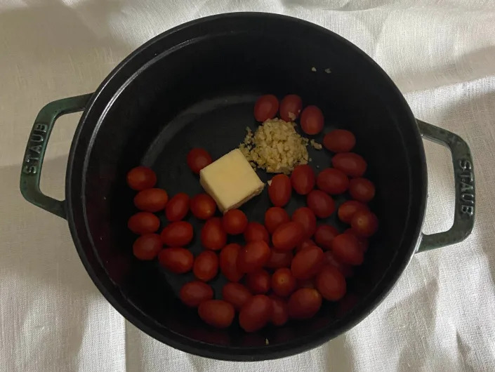 tomatoes, butter, garlic, and yeast in a dutch oven