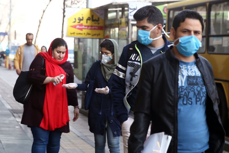 Iranian people wear protective masks to prevent contracting a coronavirus, in Tehran