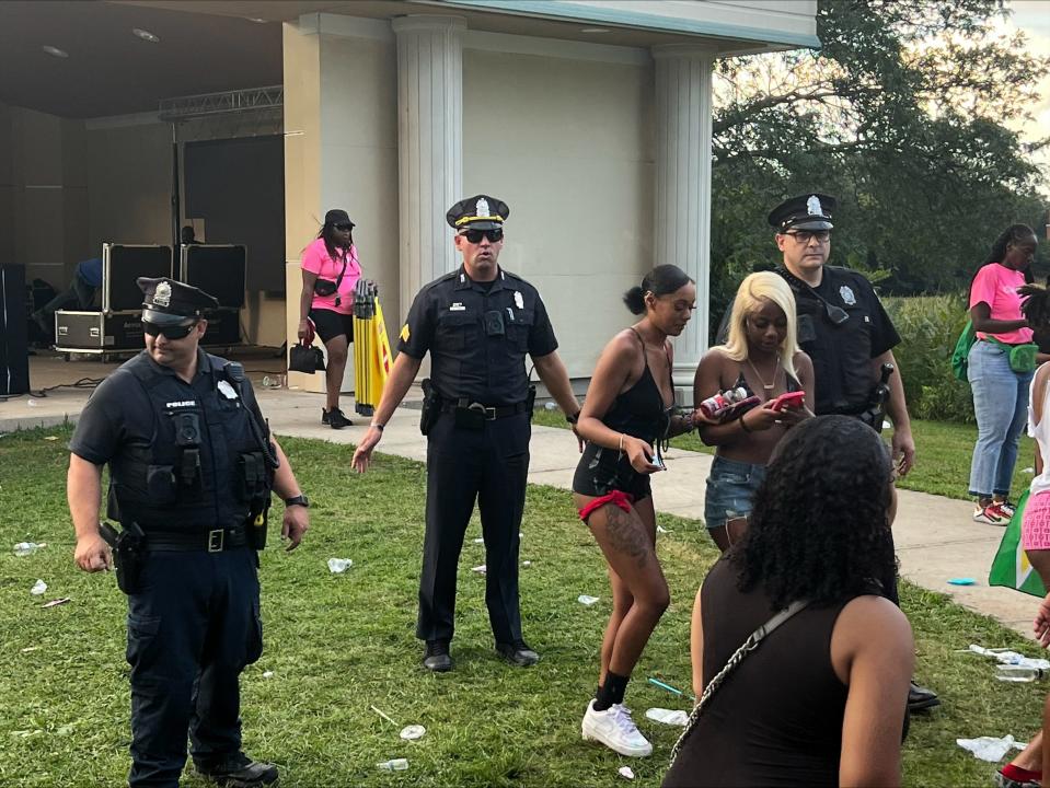 Officers clear out Institute Park, where the Worcester Caribbean American Carnival took place Sunday, after a shooting nearby.