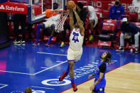 Philadelphia 76ers' Rayjon Tucker (9) goes up for a dunk against Orlando Magic's Cole Anthony (50) during the second half of an NBA basketball game, Sunday, May 16, 2021, in Philadelphia. (AP Photo/Matt Slocum)