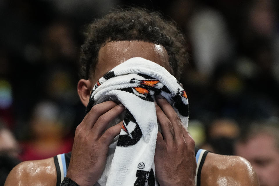 Atlanta Hawks guard Trae Young (11) wipes his face on the bench during the first half of an NBA basketball game against the Miami Heat, Saturday, Nov. 11, 2023, in Atlanta. (AP Photo/Mike Stewart)