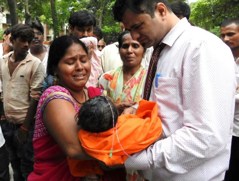 This file photo taken on August 12, 2017 shows relatives mourning the death of a child at the Baba Raghav Das Hospital in Gorakhpur, in the northern Indian state of Uttar Pradesh