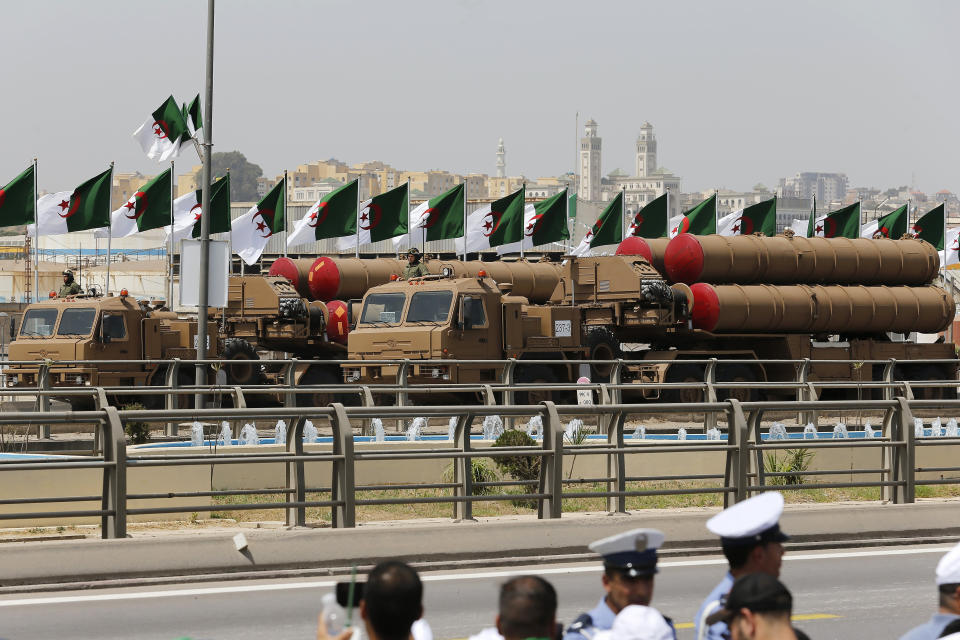 Military vehicles drive during a military parade to mark the 60th anniversary of Algeria's independence, Tuesday, July 5, 2022 in Algiers. Algeria is celebrating 60 years of independence from France with nationwide ceremonies, a pardon of 14,000 prisoners and its first military parade in years. (AP Photo/Toufik Doudou)