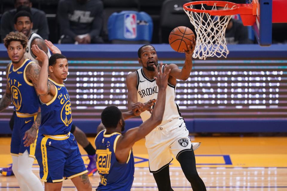 Brooklyn Nets forward Kevin Durant shoots the ball against the Golden State Warriors in the first quarter at the Chase Center.
