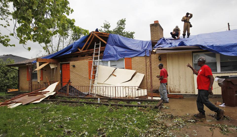 Contractors have begun working to stabilize roofs and structures throughout tornado damage areas like this house on Denlinger Road in Trotwood.  WHIO File