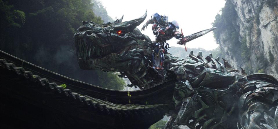 Optimus Prime rides the Dinobot named Grimlock in "Transformers: Age of Extinction."