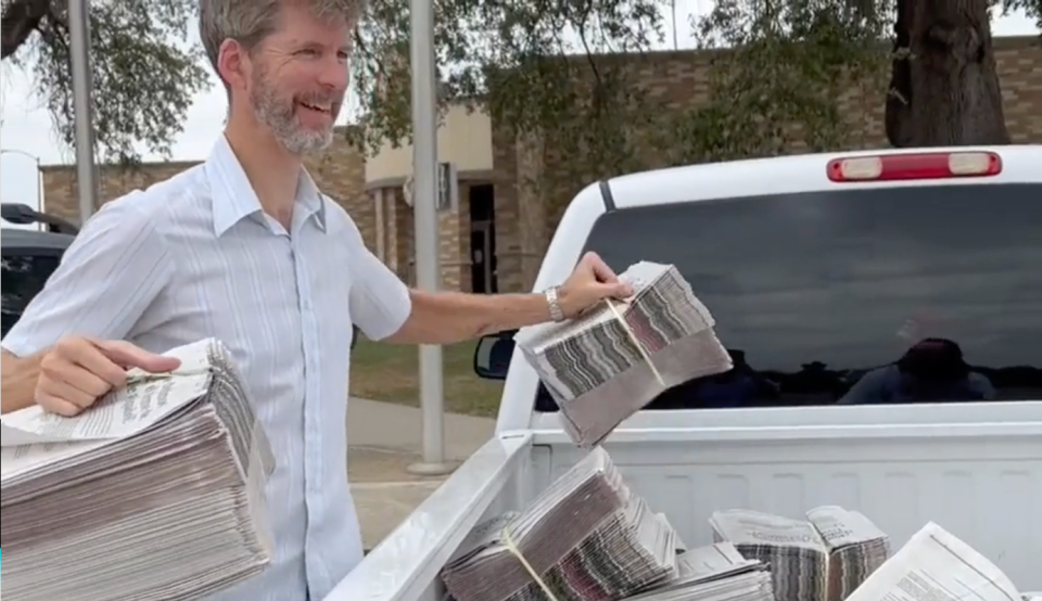 Bob Gee, Texas politics editor at the Austin American Statesman, unloads Spanish language copies of the Statesman for distribution to the community in Uvalde, Texas.
