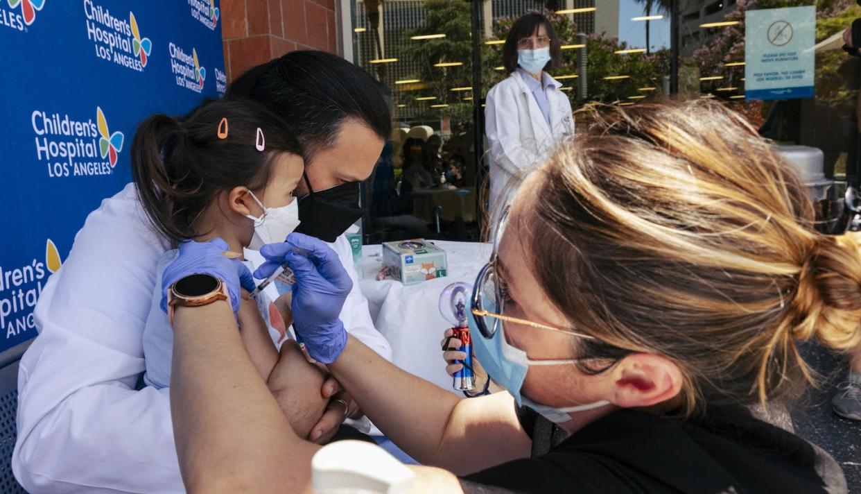 COVID-19 emergency status prompted coordinated vaccination efforts by health care providers, paramedics, volunteers and others. <a href="https://www.gettyimages.com/detail/news-photo/sofia-espinoza-tam-daughter-is-held-by-her-father-and-news-photo/1241629409?adppopup=true" rel="nofollow noopener" target="_blank" data-ylk="slk:Wesley Lapointe / Los Angeles Times via Getty Images;elm:context_link;itc:0;sec:content-canvas" class="link ">Wesley Lapointe / Los Angeles Times via Getty Images</a>