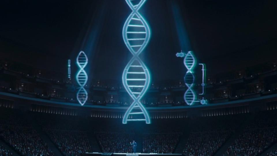 Large holograms of genetic code float above Dr. Pershing while he speaks to an arena on The Mandalorian