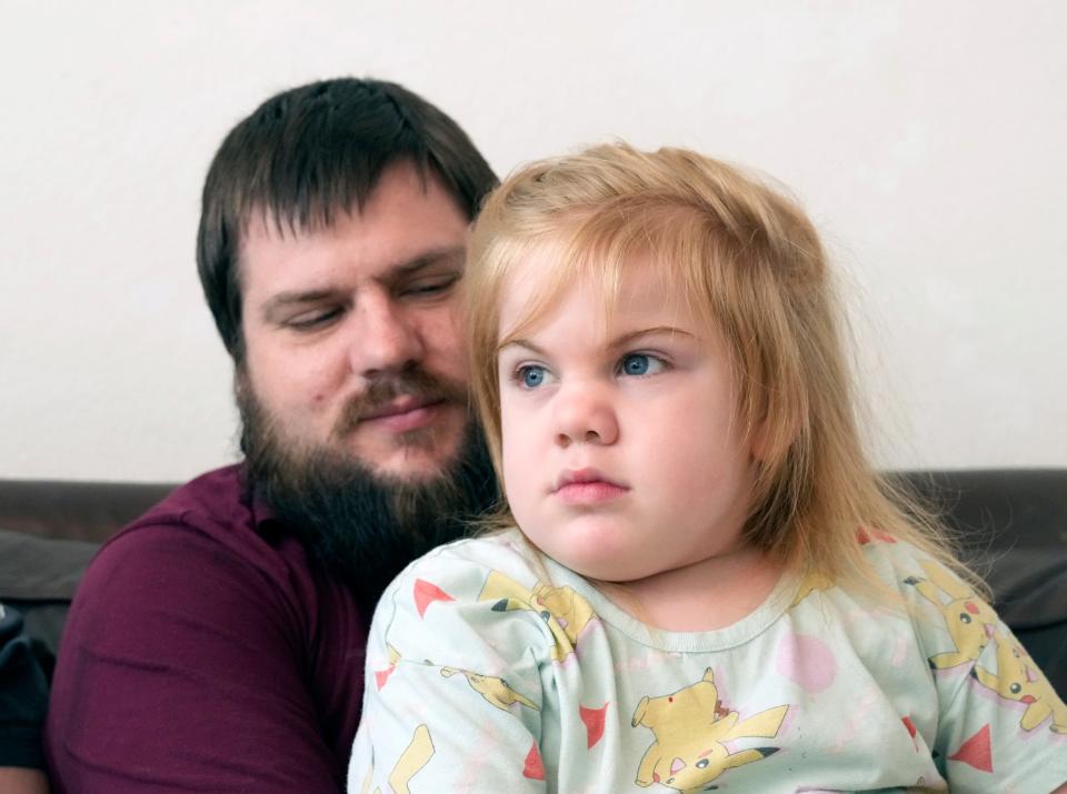 Veda Ulrich is pictured with her dad, Jericho Ulrich, in the family's Palm Coast home. She is suffering from a rare disease, Sanfilippo Syndrome, that is robbing her ability to speak and move.