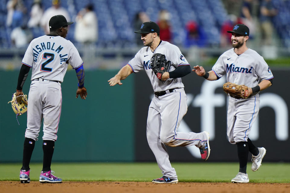 Miami Marlins' Jazz Chisholm Jr., from left, Adam Duvall and Jon Berti celebrate after the Marlins won a baseball game against the Philadelphia Phillies, Wednesday, May 19, 2021, in Philadelphia. (AP Photo/Matt Slocum)