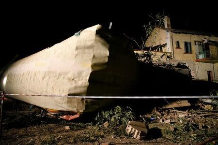 A train carriage is seen next to a house following a train derailment, in the town of Adendro in northern Greece, May 14, 2017. REUTERS/Alexandros Avramidis