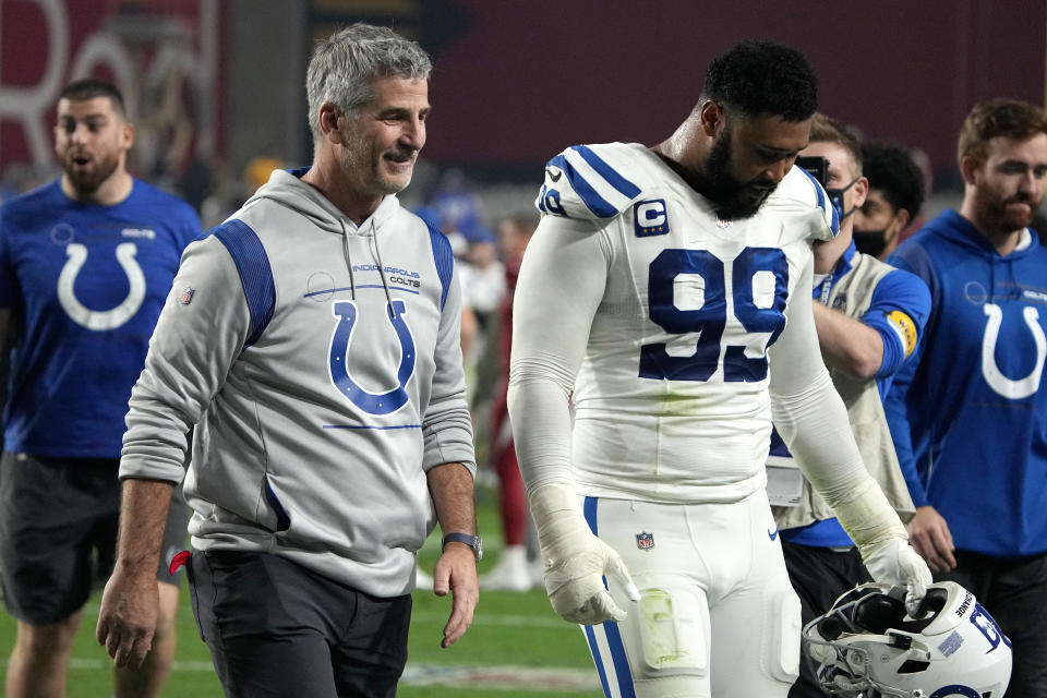 Indianapolis Colts head coach Frank Reich and defensive tackle DeForest Buckner (99) leave the field after an NFL football game against the Arizona Cardinals, Saturday, Dec. 25, 2021, in Glendale, Ariz. The Colts won 22-16. (AP Photo/Rick Scuteri)