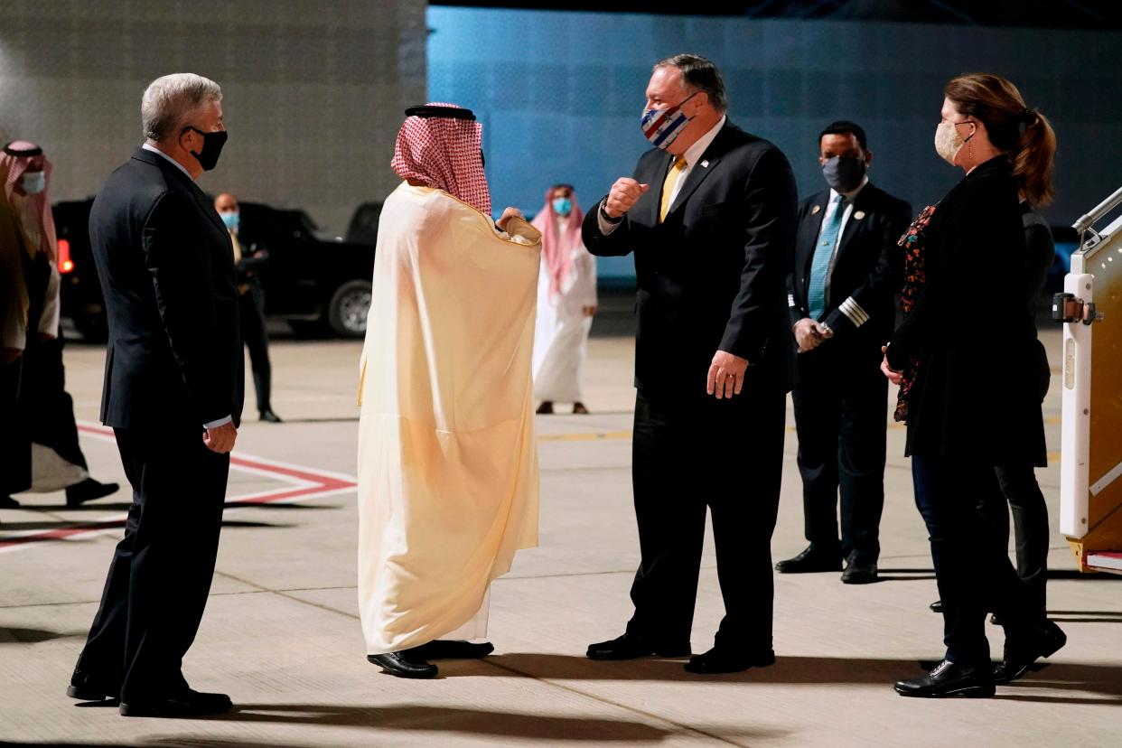 <p>Faisal bin Farhan (centre left) greets Mike Pompeo in Neom on Sunday</p> (AFP/Getty)