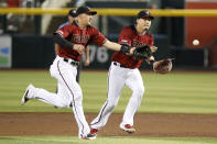 Arizona Diamondbacks shortstop Nick Ahmed, left, and second baseman Wilmer Flores vie for the ball against the San Diego Padres during the second inning of a baseball game Sunday, Sept. 29, 2019, in Phoenix. (AP Photo/Darryl Webb)