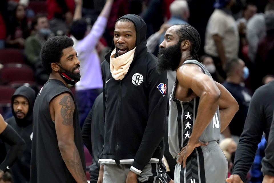 Brooklyn Nets' Kevin Durant, center, smiles with teammates Kyrie Irving, left, and James Harden.