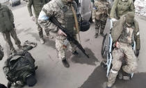 Two injured Russian soldiers, left and right, arrive at a hospital to be treated on March 10, 2022, in Mariupol, Ukraine. "They will not be as kind to us as we'll be to them," Yuliia Paievska, known as Taira, says about treating the soldiers. "But I couldn't do otherwise. They are prisoners of war." (Yuliia Paievska via AP)