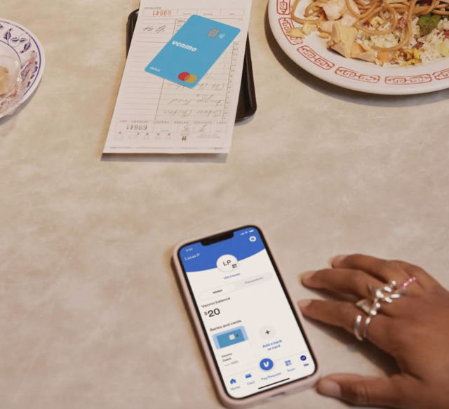 Venmo&#39;s new teen banking account on a phone next to a debit card