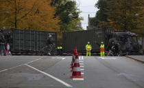 Dutch army trucks block the roads to prevent protesting farmers from reaching parliament in The Hague, Netherlands, Wednesday, Oct. 16, 2019. Thousands of Dutch farmers protest over the Netherlands efforts to drastically reduce emissions of greenhouse gases. Among the farmers' demands are that the government does not further reduce the number of animals they can keep. (AP Photo/Peter Dejong)