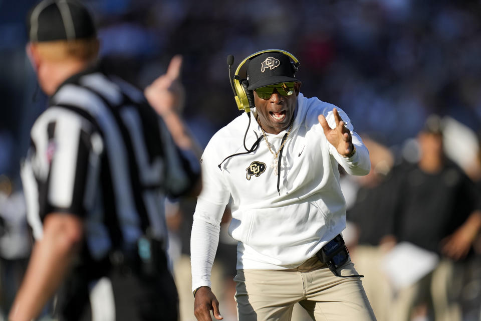 Colorado head coach Deion Sanders, right, argues with line judge Bob Day, left, during the first half of an NCAA college football game against Arizona State, Saturday, Oct. 7, 2023, in Tempe, Ariz. (AP Photo/Ross D. Franklin)