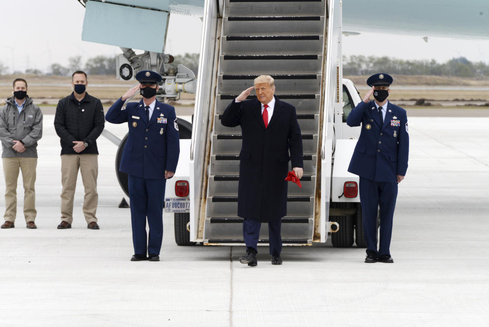 President Donald Trump salutes as he steps off Air Force One upon arrival at Valley International Airport, Tuesday, Jan. 12, 2021, in Harlingen, Texas. (Miguel Roberts/The Brownsville Herald via AP)