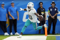 Miami Dolphins wide receiver Tyreek Hill celebrates his touchdown catch during the second half of an NFL football game against the Los Angeles Chargers Sunday, Sept. 10, 2023, in Inglewood, Calif. (AP Photo/Ashley Landis)
