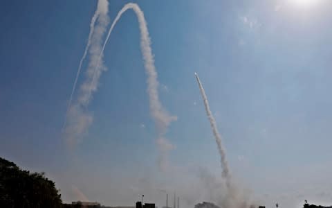 Most of the projectiles were shot down by Israel's Iron Dome missile system - Credit: MENAHEM KAHANA/AFP/Getty Images