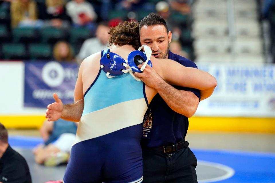 Paramus' Daniel Elyash hugs head coach Chris Falato after winning his 285-pound quarterfinal bout on day two of the NJSIAA state wrestling tournament in Atlantic City on Friday, March 3, 2023.