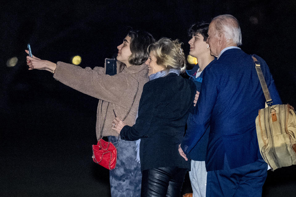 President Joe Biden, first lady Jill Biden, and their grandchildren Natalie and Robert, take a selfie before boarding Marine One on the South Lawn of the White House in Washington, Tuesday, Dec. 27, 2022, for a short trip to Andrews Air Force Base, Md., and then on to St. Croix, U.S. Virgin Islands. (AP Photo/Andrew Harnik)