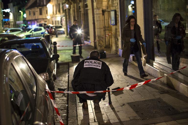 Policemen collect evidence on December 21, 2014 in Dijon on the site where a driver shouting "Allahu Akbar" ploughed into a crowd