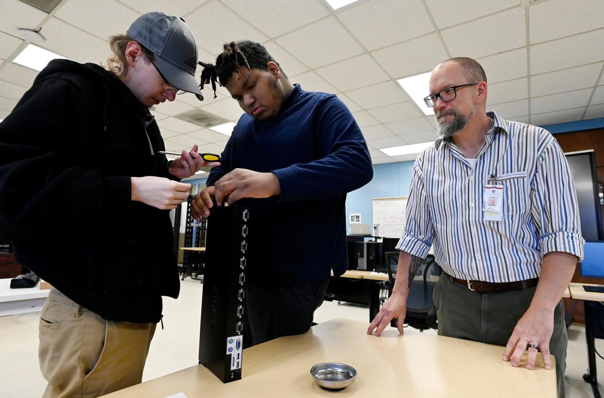 Instructor Joe Redemske, right, watches as Max Rivers, 19, left, and Isaiah Bryant, 18, work on a control computer before installing it into a server rack during a computer information technology class at the Tennessee College of Applied Technology  in Portland. Students at TCAT are taking classes to improve skills for jobs with in-demand industries.