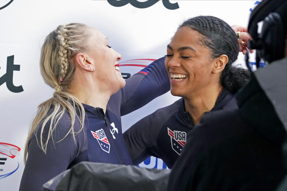 Third placed Kaillie Humphries and Kaysha Love of USA celebrate after their second run of the two-woman Bobsleigh World Cup race in Sigulda, Latvia, Sunday, Feb. 19, 2023. Love is moving from push athlete to driver for the U.S. and will make her World Cup debut as a pilot next month with hopes of moving closer to a spot in the 2026 Olympics. (AP Photo/Oksana Dzadan, File)