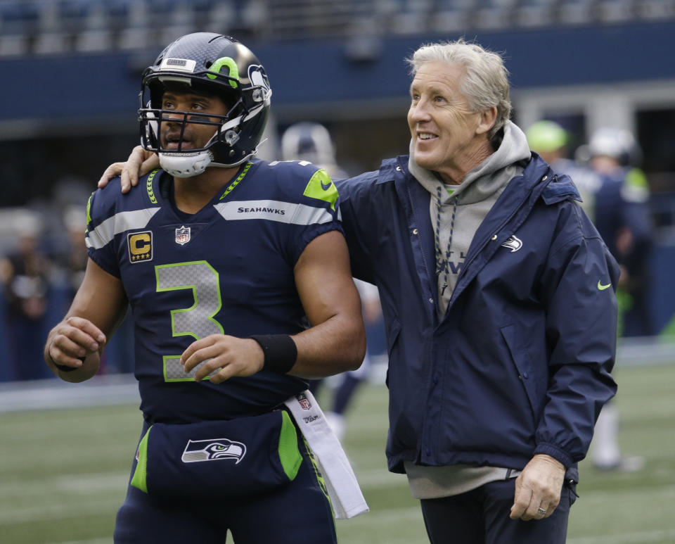 Russell Wilson and Pete Carroll have the Seahawks in the mix for another playoff berth. (AP)