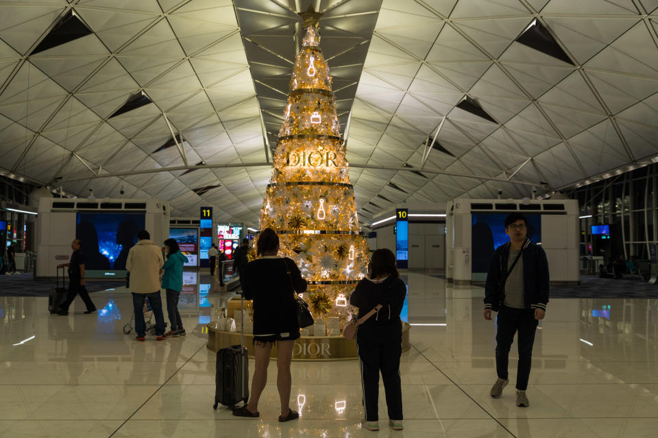 Travelers are taking pictures near a Dior-themed Christmas tree in the Hong Kong International Airport in Hong Kong, China, on November 21, 2023. (Photo by Marc Fernandes/NurPhoto via Getty Images)