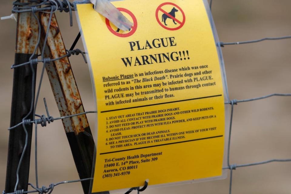A bubonic plague warning sign is displayed at a parking lot near the Rocky Mountain Arsenal Wildlife Refuge. (AP)