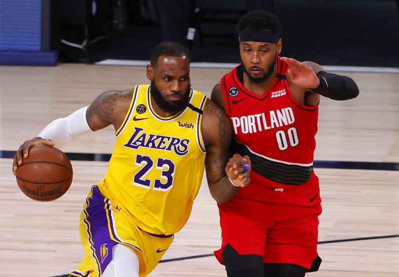 Lakers forward LeBron James drives on Portland Trail Blazers forward Carmelo Anthony during Game 2.