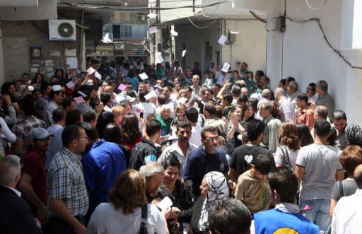 Syrians wait to cast their vote in parliamentary elections outside a polling station in Damascus on May 7, 2012. The UN has slammed the Syrian government for holding a national election on Monday despite the ongoing violence and for failing to involve all parties