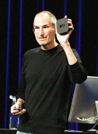 The late Steve Jobs holds an Apple TV device at an event in San Francisco, California in 2010. Apple sold 2.8 million Apple TV devices last year and nearly that many in the first few months of this year, according to current CEO Tim Cook