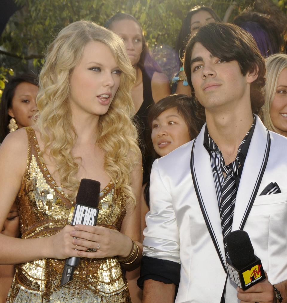 Close-up of Taylor and Joe holding microphones